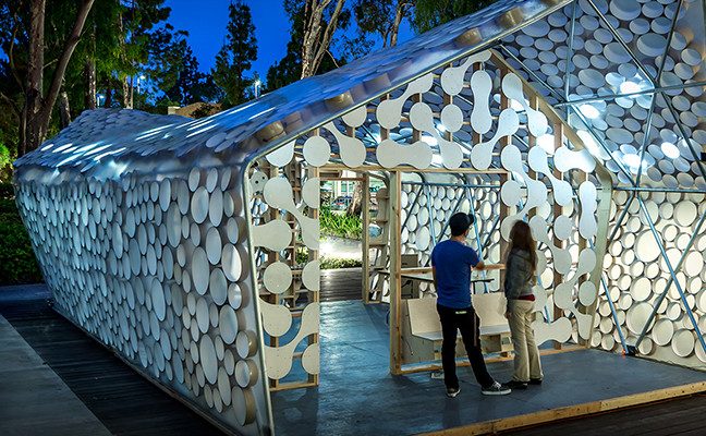 Man and woman standing outside concept model for sustainable home construction