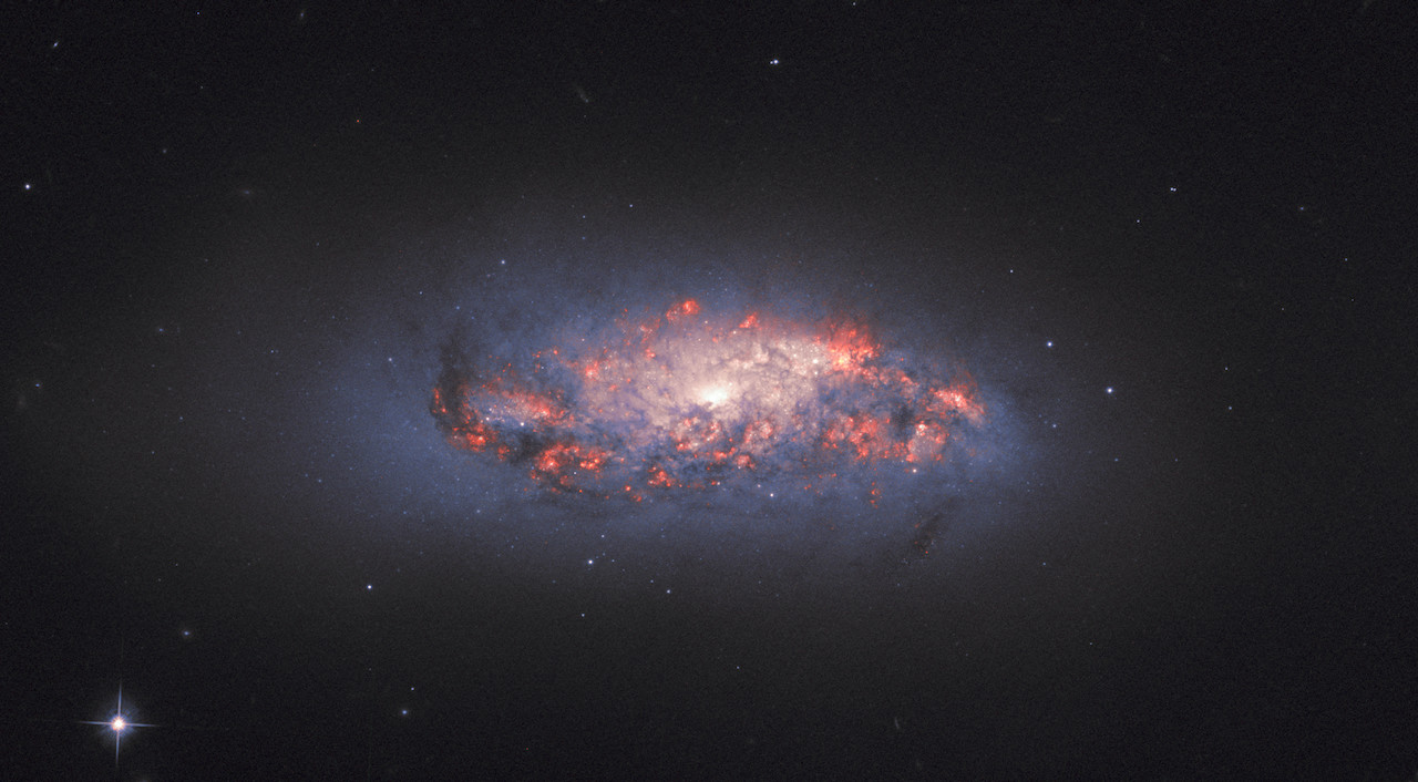 This image from the Hubble Space Telescope shows pockets of star formation. The glow is created by hydrogen gas reacting with light from nearby stars.