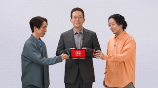 One person is holding the Switch 2, while two others are placing the new joycons onto the console.