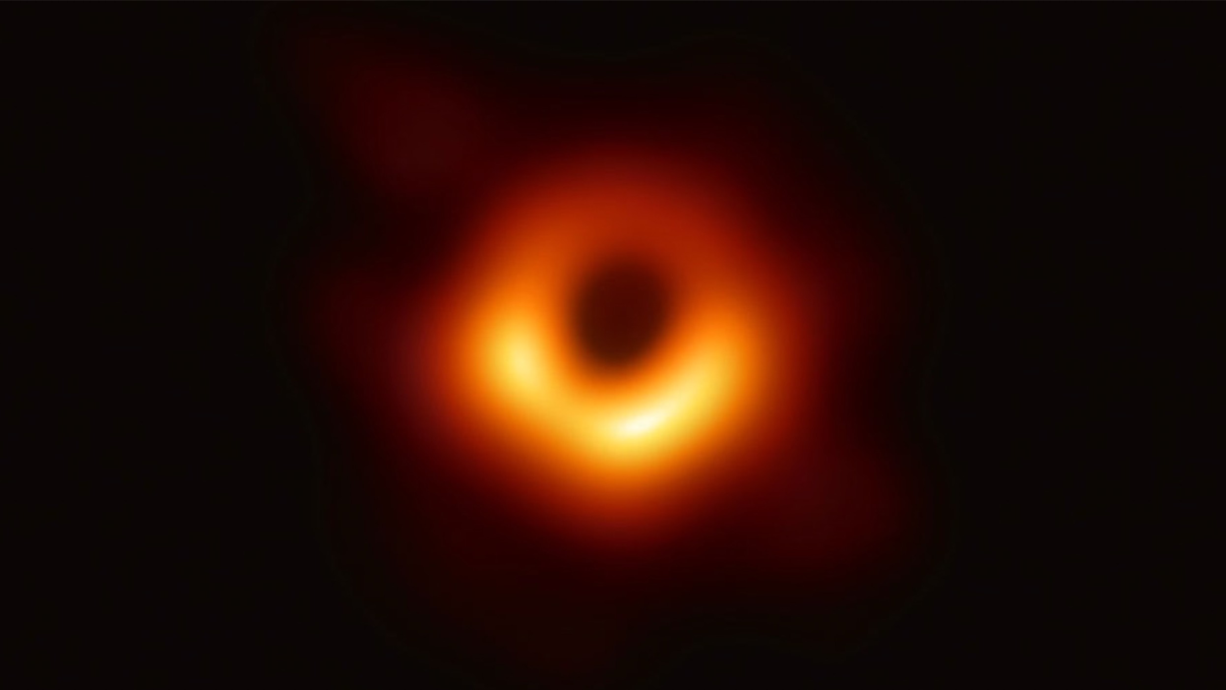 A glowing golden ring against a black background the bottom of the ring is brighter than the top
