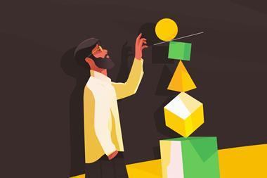 Man balancing pile of geometric shapes