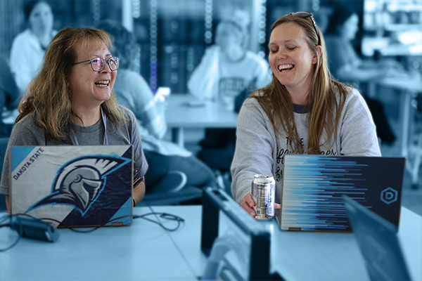 Two students talking to each other in class