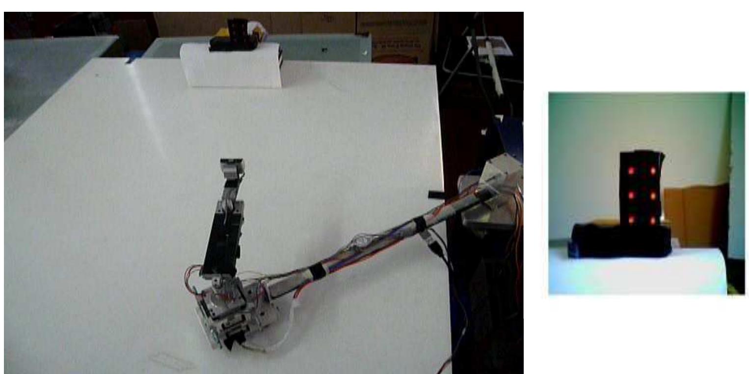 Figure 7: The robotic arm equipped with a camera at the end effector and performing autonomous rendezvous to a target featuring red LEDs 