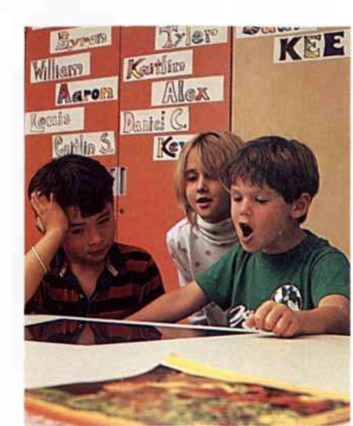 CHILDREN AT A COMPUTER in the Open School are clearly engrossed in their work. If used properly, the author notes, computers can be “powerful am- plifiers, extending the reach and depth of the learners.” 