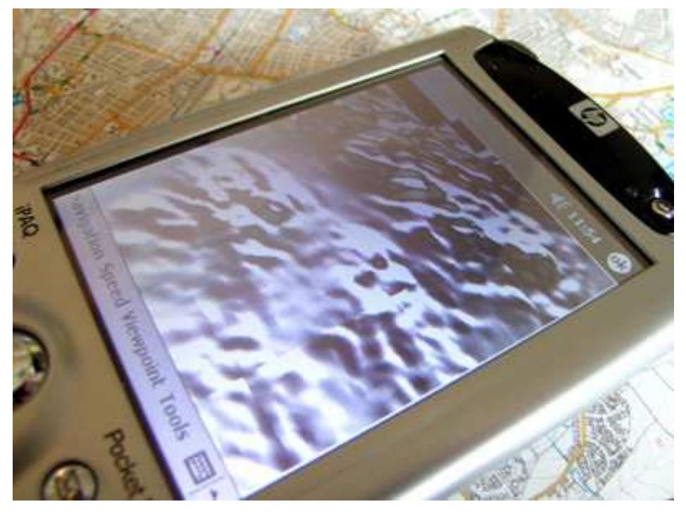 Figure 2 illustrates an interactive 3D map of north of England displayed on a PDA (ipaq 5450 pocketPC). The 3D map is displayed using pocket Internet Explorer with a VRML plug-in from pocket Cortona by ParallelGraphics. To increase the level of realism of the VR interface, we have added collision detection to the 3D models so that users can navigate more naturally. 