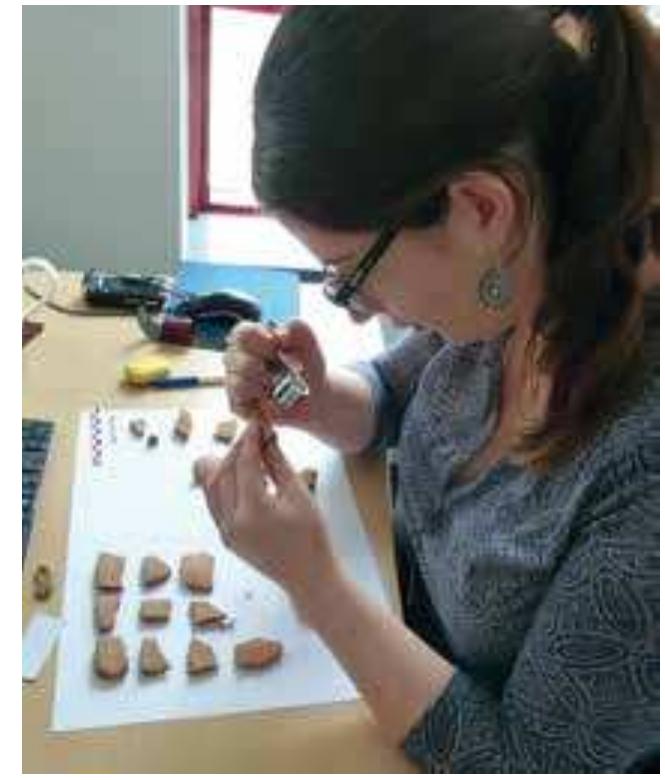 Fig. 33 Nina Maaranen checking samples (photo: © The Enigma of the Hyksos)  Fig. 32 Sarah Vilain examining ceramic material (photo: © The Enigma of the Hyksos)  Silvia Prell (RT3) progressed with the compilation and analyses work on equid burials in Egypt and the Levant, she also started work on analyses of warrior burials in the same area. Rosa Matic (Project Manager) co-ordinated, supported the team in all administrative tasks, necessary travel arrangements and assisted with the acquisition of literature. She also continues to act as the interface between the bio-archaeological team at Bournemouth University under Holger Schut- kowski and the team in Vienna, supplying updates and disseminating the communication between various research tracks, when and where relevant. 