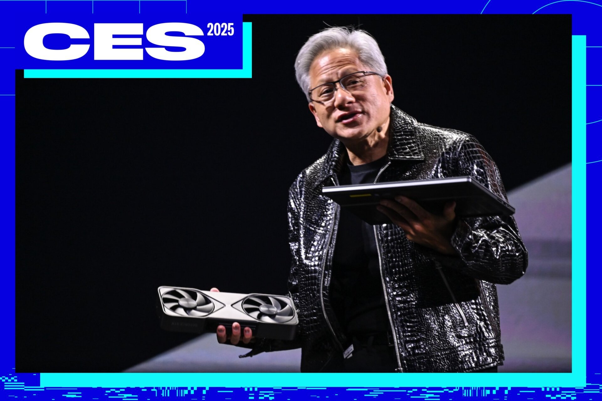 Nvidia Ceo Jensen Huang holding up a Rtx 50 Series Gpu and a 50-series powered laptop.