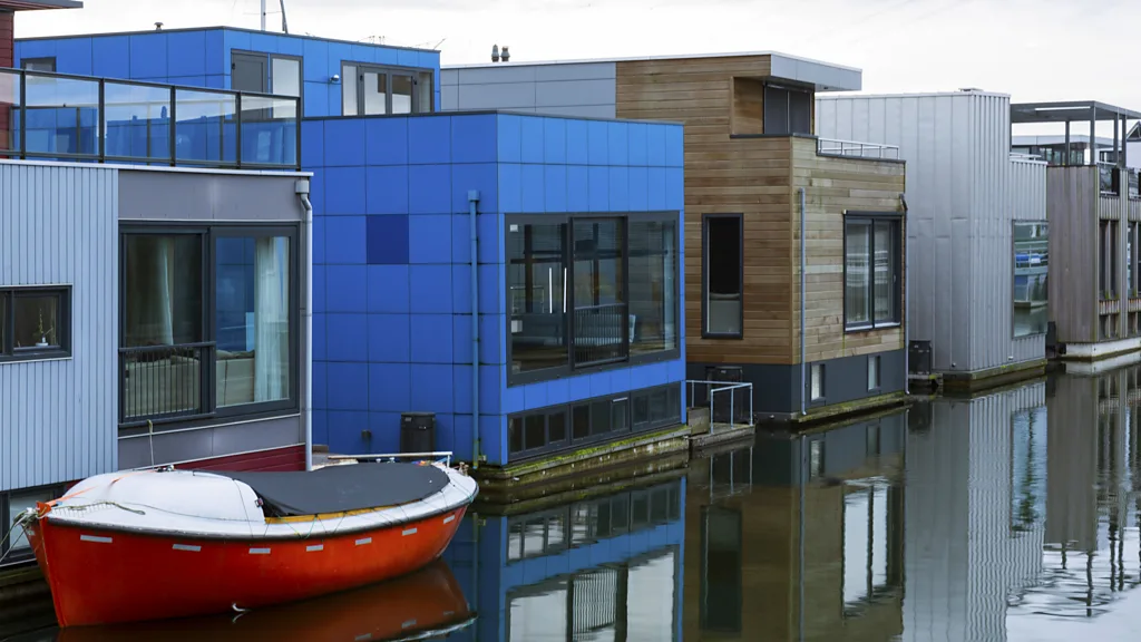 A row of homes floating in a canal.