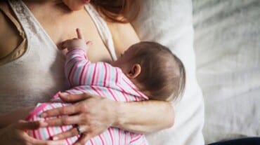 A woman breastfeeding her baby