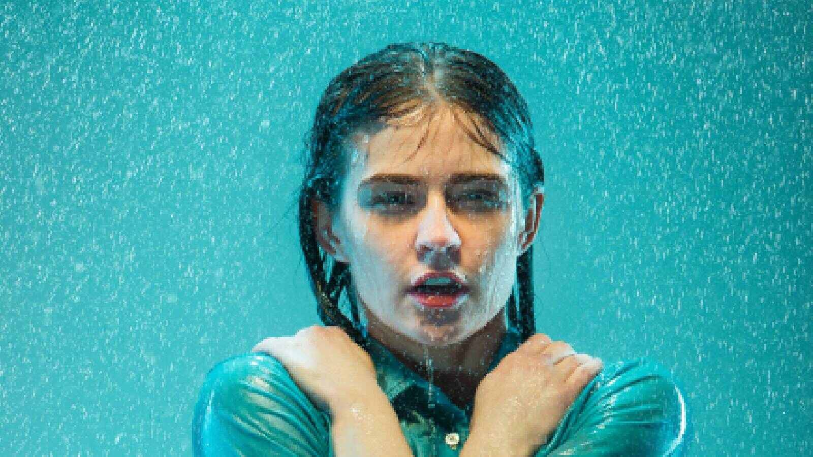 A gir getting wet in the rain