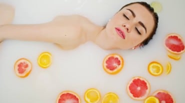 A woman taking a milk bath