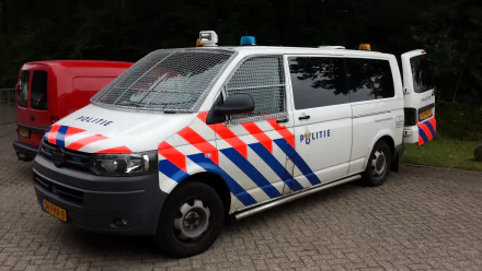 4K Ultra HD desktop wallpaper featuring a white police van with red and blue stripes parked on a paved area surrounded by greenery.