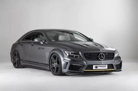 HD desktop wallpaper of a matte gray Mercedes‑Benz CLS‑Class sedan tuned by Prior Design, featuring an aggressive body kit, lowered stance and black alloy wheels in a studio shot.