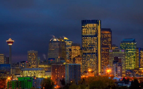 Nighttime skyline of Calgary, Alberta, Canada, illuminated with city lights against a dark sky, captured as an HD man-made urban desktop wallpaper.