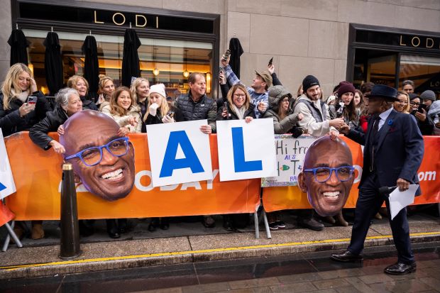 Al Roker greeting fans on the street.