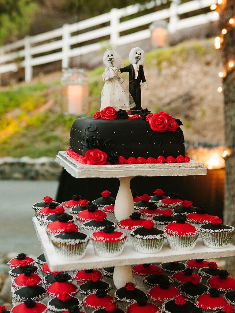 Small black wedding cake with black and red cupcakes