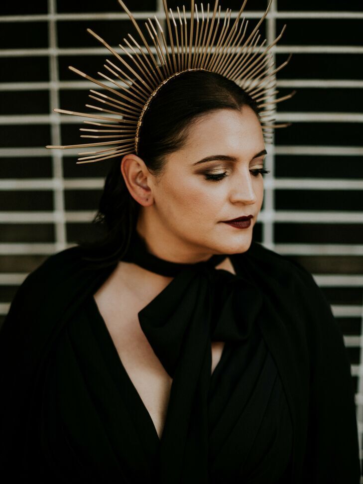 Bride wearing dark makeup and gold headpiece at a Halloween wedding