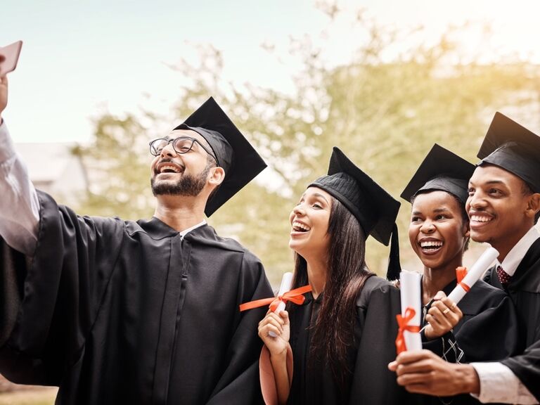 Graduates posing for a selfie on graduation day