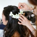 Hairstylist does bride's hair on her wedding day