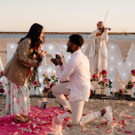 Man proposing to woman on the beach 