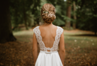 Bride with low bun braided wedding hairstyle