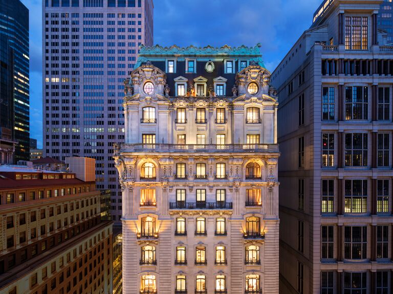 St. Regis Hotel exterior at dusk all lit up in nyc