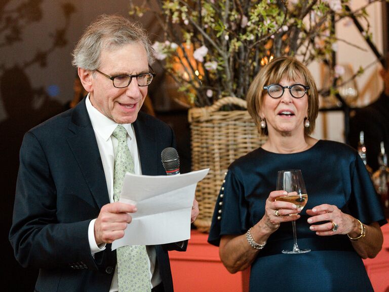 Father of the groom giving speech during wedding reception.