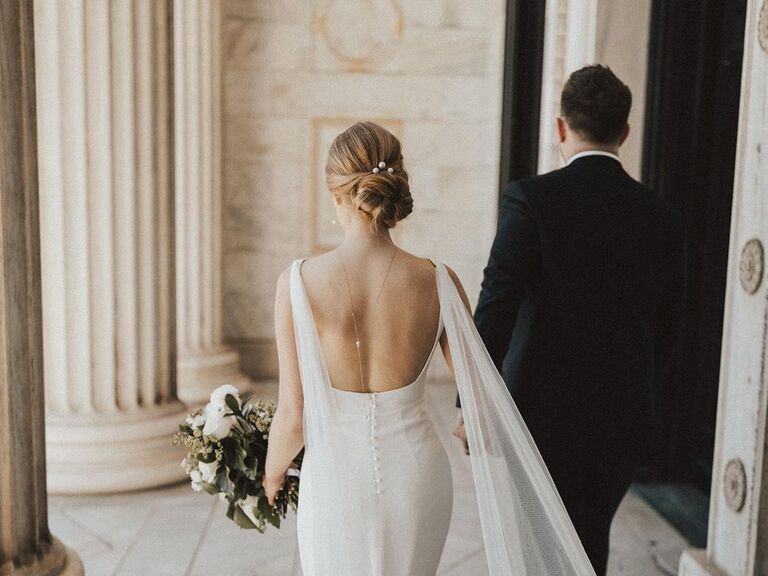 Bride with open-back wedding dress and updo hairstyle