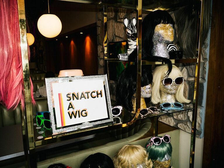 Wig wall at a Halloween-themed wedding