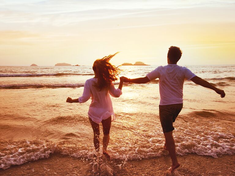 Couple holding hands on the beach