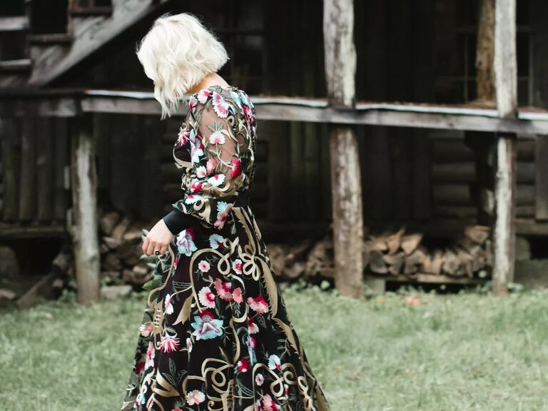 Bride in a funky black dress shows off a stylish platinum blonde bob. 