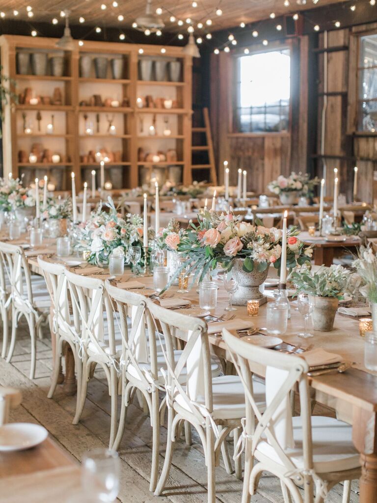 Rustic barn reception with wood cross-back chairs