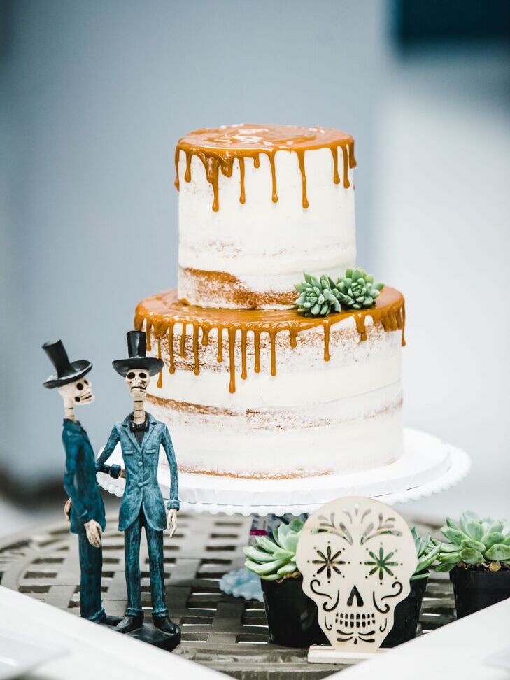 Semi-naked wedding cake with caramel topping at a Halloween wedding