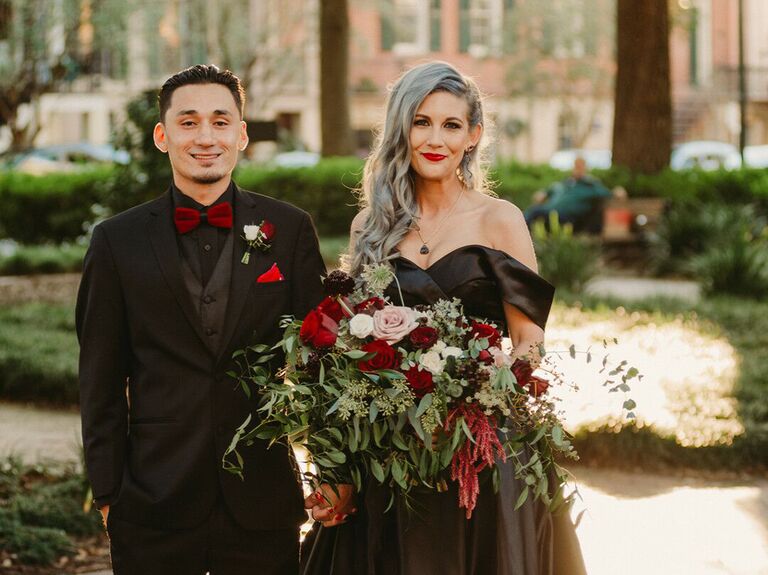 Couple dressed in black at their Halloween-themed wedding