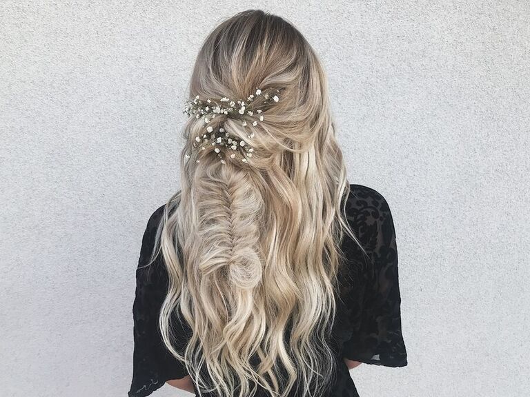 Bride wears her hair in a bohemian style for her wedding. 