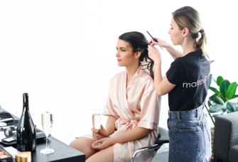 Bride getting hair styled on wedding day