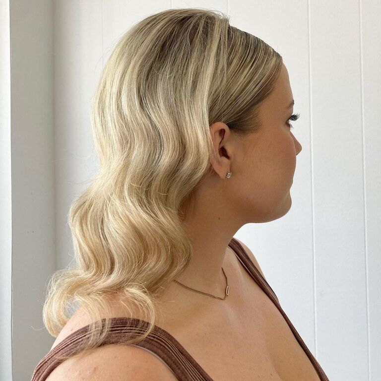 Sleek curls medium length bridesmaid hairstyle