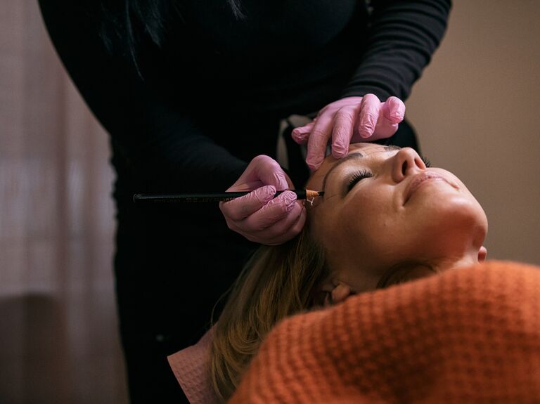 Bride having eyebrows microbladed before wedding