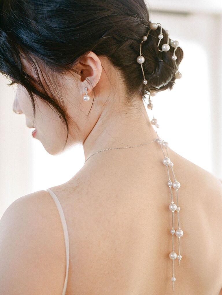 Twisted updo wedding hair trend with pearls