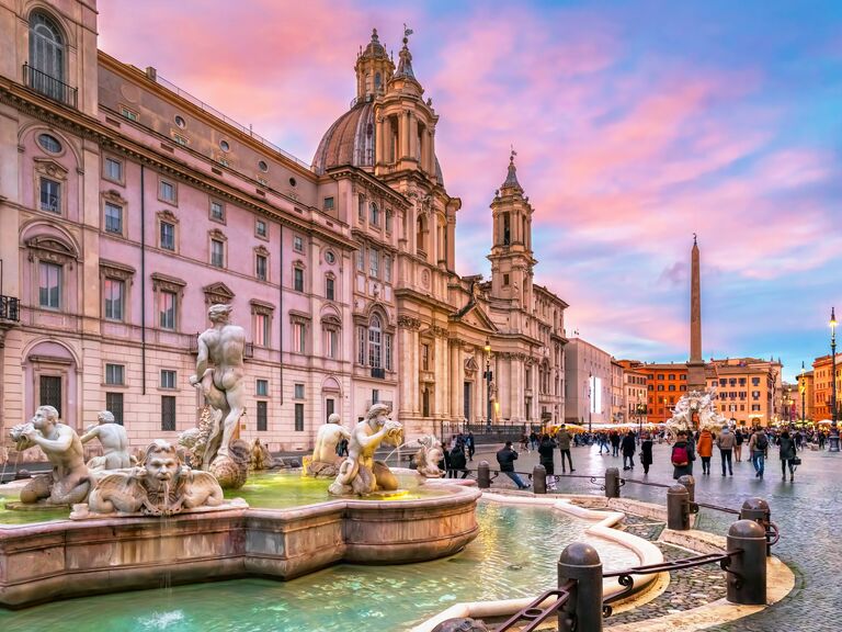 Piazza Navona in Rome, Italy, in front of a pink sky