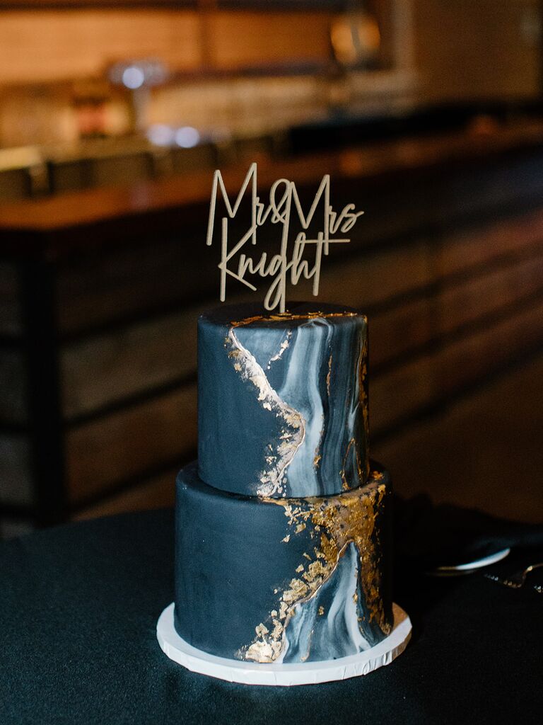 Black marble wedding cake with custom topper. 