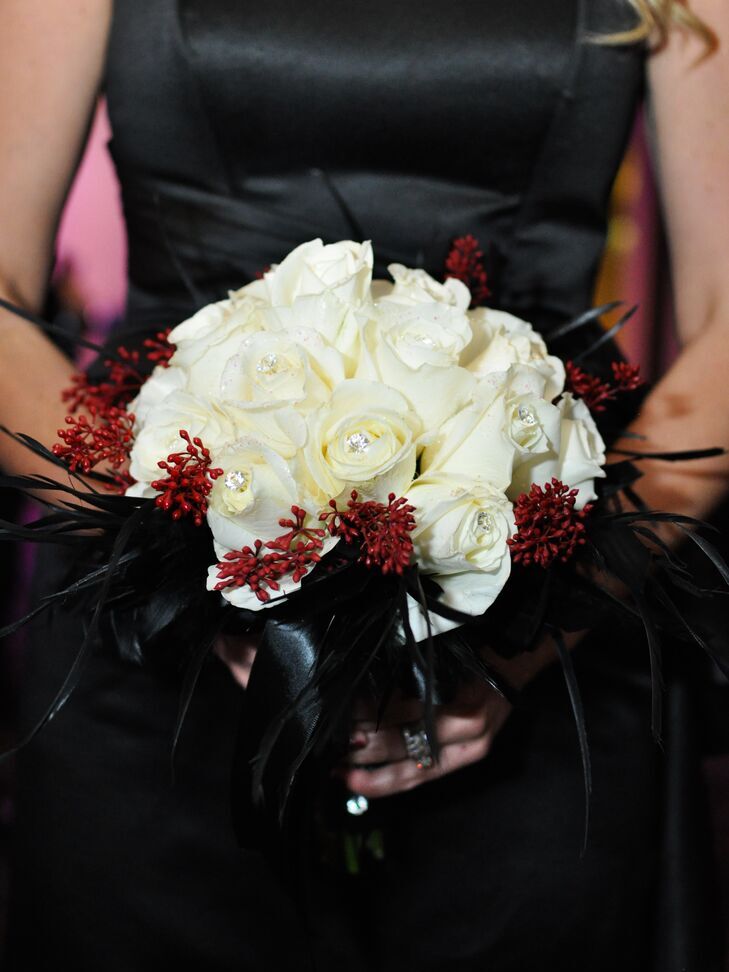 White rose and black feather bouquet at a Halloween wedding