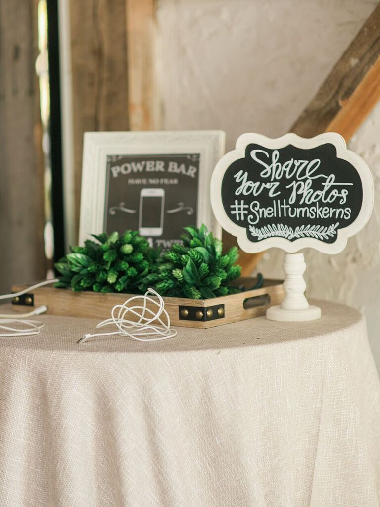 Sign at cellphone charging station with the wedding hashtag "#Snellturnskerns"