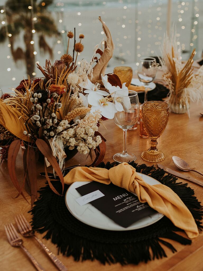 Orange and black tablescape at a Halloween-themed wedding