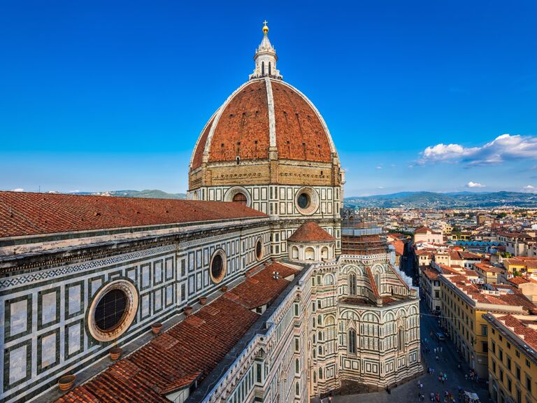 Stunning view of the Duomo, a beautiful cathedral with circular windows and a round tower. 