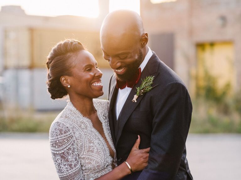 Smiling couple embraces at sunset. 