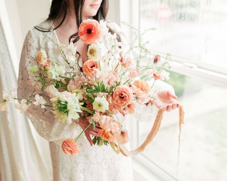 Bride holding whimsical pink poppy wedding bouquet