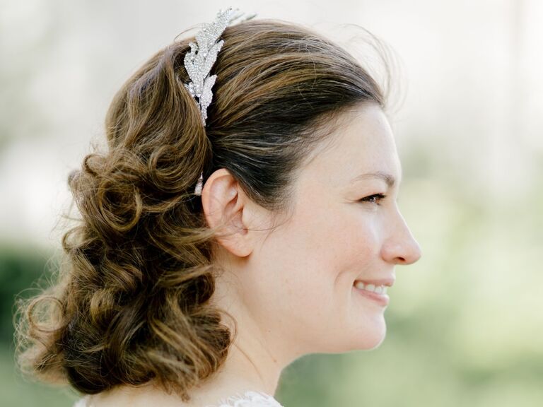 Bride shows off her classic short curls with an embellished headband. 