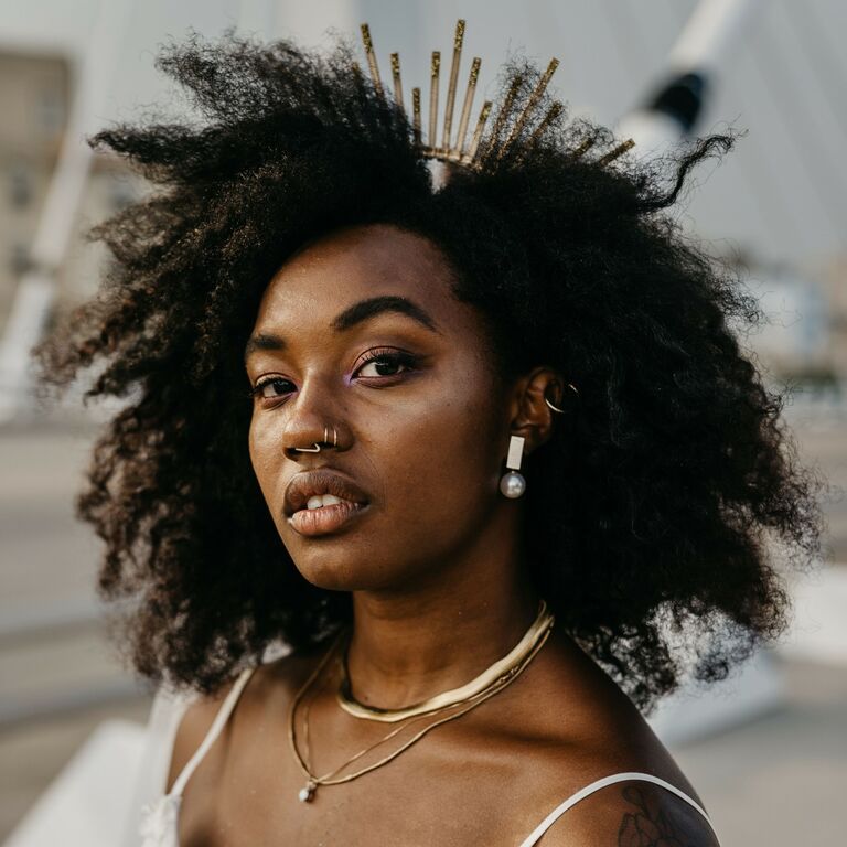 Bride wears her natural hair adorned with an eye-catching crown. 