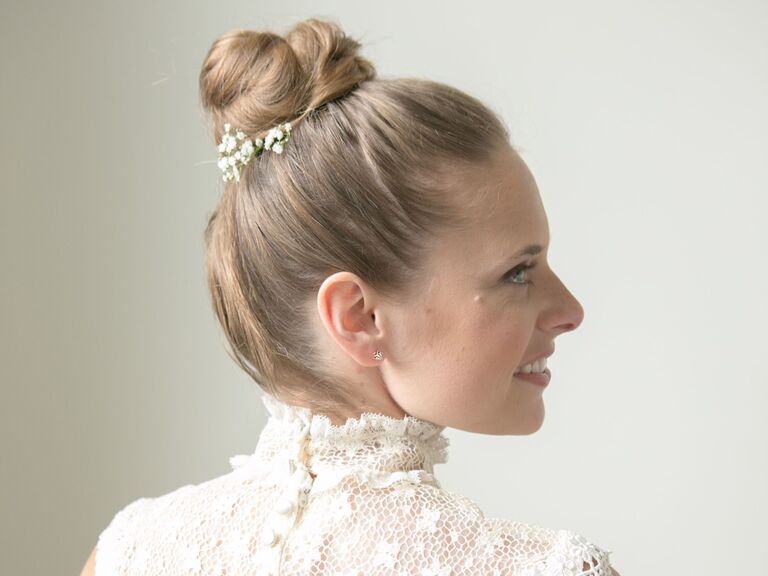 Bride wears her hair in an elegant ballerina bun. 